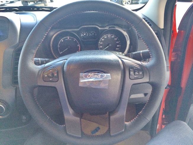 Orange Ford Ranger Wildtrak Interior steering with its controls